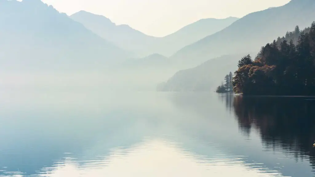 A mirrored mountain lake reflection picture to represent how individualized coaching with Avery helps give the high achiever more clarity on how to stop feeling out of control and achieve balance